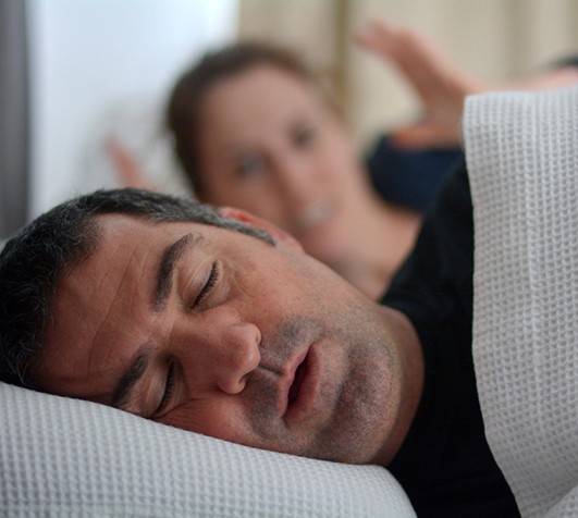 Man sleeping next to woman