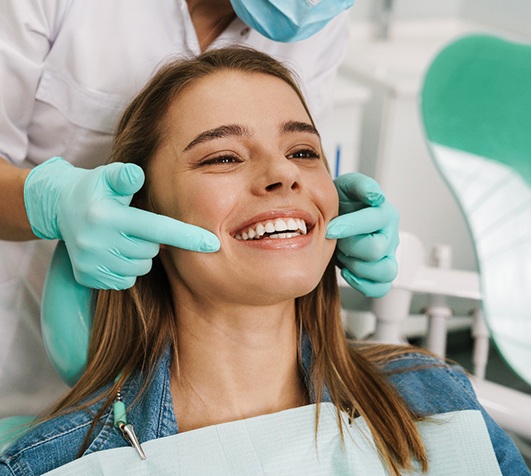 Closeup of patient’s mouth while dentist performs oral exam