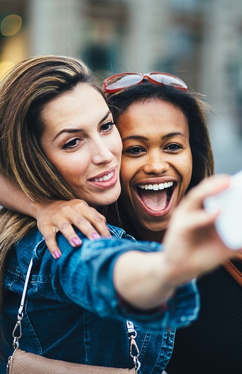 Two women with beautiful smile after cosmetic dentistry