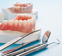 full dentures sitting on a mold of a mouth