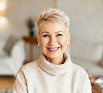 Senior woman in sweater with dental implants in New Bedford, MA