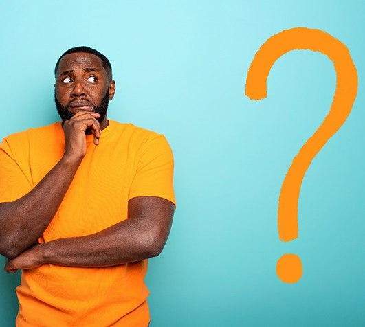 Man with orange question mark and dental implants in New Bedford