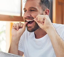 Man flossing his teeth