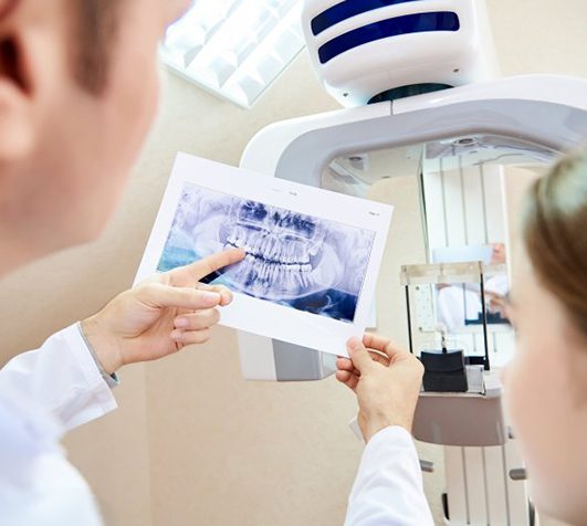 Dentist showing patient her CBCT scan