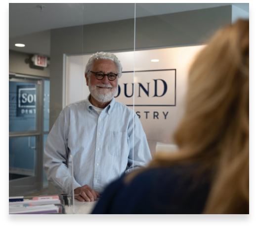 Dental patient checking in at reception desk