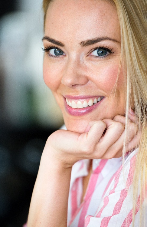 a woman smiling after undergoing Invisalign in New Bedford