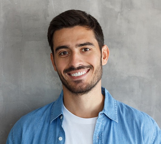 a man smiling after getting Invisalign in New Bedford