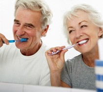older couple brushing teeth together 