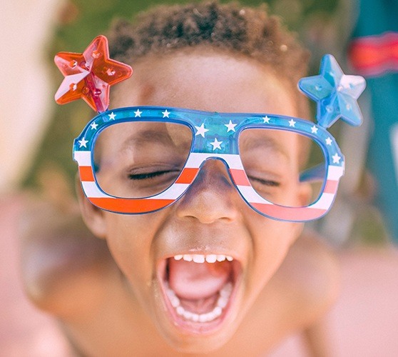 Child laughing after dental sealants placement