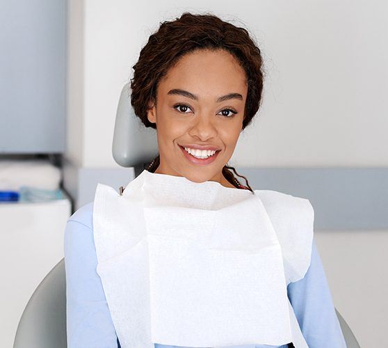 Woman smiling during dental checkup and teeth cleaning visit