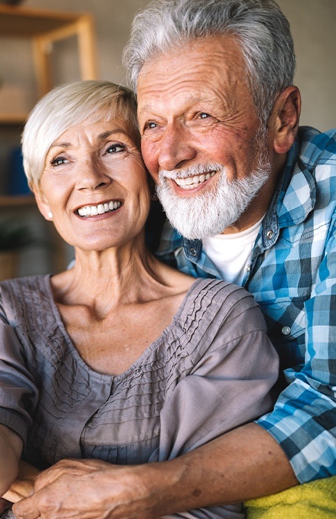 Man and woman with healthy smiles after restorative dentistry