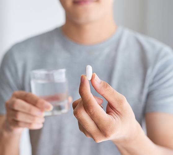 Patient holding an oral conscious dental sedation pill