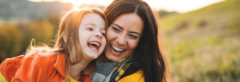 Mother and daughter smiling after children's dentistry visit