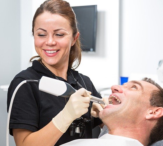 Dental team member using cavity detection system