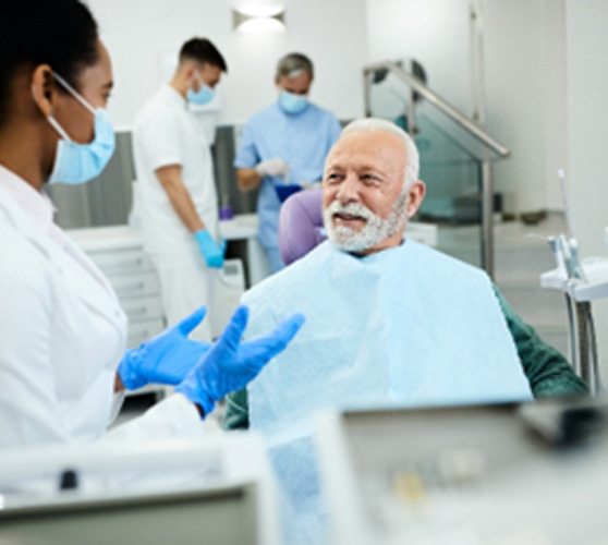 Dentist explaining treatment to smiling patient