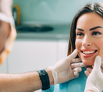 A dentist assessing a woman for cosmetic dentistry